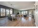 Open-concept living space combining dining and living areas with large windows and modern decor at 127 Country Gate Ln, Summerville, SC 29485