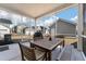 View of a covered patio furnished with a dining table, chairs, and grill, perfect for outdoor entertaining at 127 Country Gate Ln, Summerville, SC 29485