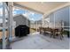 A covered outdoor patio with dining table, chairs and grill offering a relaxing space for outdoor enjoyment at 127 Country Gate Ln, Summerville, SC 29485