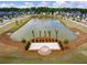Scenic community pond featuring a gathering place and multiple palm trees around the water at 127 Country Gate Ln, Summerville, SC 29485