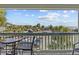 Relaxing balcony view with seating overlooking tropical landscaping and parking at 1300 Ocean Blvd # 238, Isle of Palms, SC 29451