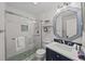 Bathroom featuring glass shower, vanity, modern fixtures, and decorative mirror at 1300 Ocean Blvd # 238, Isle of Palms, SC 29451