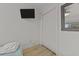 Bedroom with TV and a sliding door closet and decorative mirror at 1300 Ocean Blvd # 238, Isle of Palms, SC 29451