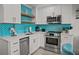 Modern kitchen features stainless steel appliances and vibrant blue backsplash at 1300 Ocean Blvd # 238, Isle of Palms, SC 29451