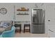 Kitchenette area with stainless steel refrigerator, counter seating and coastal decor at 1300 Ocean Blvd # 238, Isle of Palms, SC 29451