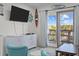 Bright living room with large screen TV and sliding door access to outside balcony at 1300 Ocean Blvd # 238, Isle of Palms, SC 29451