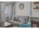 Comfortable living room with sofa, nautical decor and balcony access at 1300 Ocean Blvd # 238, Isle of Palms, SC 29451