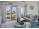 Comfortable living room with neutral colors and access to a balcony with a view at 1300 Ocean Blvd # 238, Isle of Palms, SC 29451