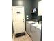 Functional laundry room with modern washer and dryer, shelving, and access to the outside at 1346 Ashley Gardens Blvd, Charleston, SC 29414