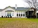 Rear exterior showcasing a well-maintained lawn, screened porch and many large windows at 1346 Ashley Gardens Blvd, Charleston, SC 29414