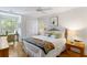 Cozy bedroom featuring a ceiling fan, light hardwood floors, and windows for lots of natural light at 1346/48 Pelican Watch, Seabrook Island, SC 29455