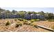 Exterior view of multiple condominium units surrounded by lush greenery and dunes at 1346/48 Pelican Watch, Seabrook Island, SC 29455