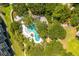 Overhead shot of community pool showcasing lush greenery, pool, and surrounding buildings at 1401 Ocean Club Dr, Isle of Palms, SC 29451