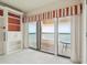 Water view seen from an outdoor balcony with glass sliding doors leading to an interior room with built in shelves at 1401 Ocean Club Dr, Isle of Palms, SC 29451