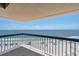 A lovely balcony view overlooking a sandy beach with ocean water on a clear and sunny day at 1401 Ocean Club Dr, Isle of Palms, SC 29451