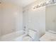 Bright bathroom features a clean white tiled shower-tub combo, toilet, and mirrored vanity at 1401 Ocean Club Dr, Isle of Palms, SC 29451