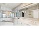 Primary bath boasts dual sinks, vanity, large mirrors, whirlpool soaking tub, and access to the bedroom at 1401 Ocean Club Dr, Isle of Palms, SC 29451