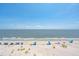 Expansive beach view with blue umbrellas, chairs, and clear skies perfect for a relaxing day at 1401 Ocean Club Dr, Isle of Palms, SC 29451
