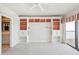Bright bedroom showcasing custom built-ins, soft carpet, and a large sliding door to a private balcony with water views at 1401 Ocean Club Dr, Isle of Palms, SC 29451