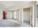 Bright bedroom featuring a large window, sliding glass door, and an adjacent closet for ample storage space at 1401 Ocean Club Dr, Isle of Palms, SC 29451