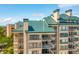 Close exterior of condo with balconies overlooking trees and views at 1401 Ocean Club Dr, Isle of Palms, SC 29451