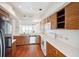 A quaint eat-in kitchen with oak cabinets, white countertops and appliances, as well as a small window to the exterior at 1401 Ocean Club Dr, Isle of Palms, SC 29451