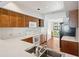 The kitchen features oak cabinets, white countertops, stainless steel sink, and standard white appliances at 1401 Ocean Club Dr, Isle of Palms, SC 29451