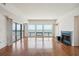 Spacious living room features a fireplace, large windows with ocean views, and hardwood floors at 1401 Ocean Club Dr, Isle of Palms, SC 29451
