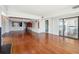 Bright, open living area featuring hardwood floors, built-in shelving, and a sliding glass door to a balcony with ocean views at 1401 Ocean Club Dr, Isle of Palms, SC 29451