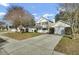 Lovely home with a quaint front porch, white picket fence, and attached garage with long driveway at 147 Moon Dance Ln, Summerville, SC 29483