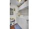 Efficient laundry room with white appliances, overhead storage, and blue patterned floor mat at 147 Moon Dance Ln, Summerville, SC 29483