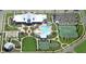 Stunning aerial view of a community clubhouse, pool, tennis courts, and manicured green spaces at 2014 Barn Swallow Rd, Summerville, SC 29483