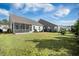 Lush backyard showcasing lawn, patio, screened porch and landscaping, creating a serene outdoor oasis at 2014 Barn Swallow Rd, Summerville, SC 29483