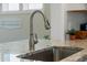 Close-up of the kitchen sink, highlighting the granite countertop and modern faucet at 2014 Barn Swallow Rd, Summerville, SC 29483