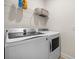 The laundry room showcases a modern washer and dryer with a shelf for storage at 2014 Barn Swallow Rd, Summerville, SC 29483