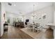 Open-concept living room and dining area featuring hardwood floors and ample natural light at 2014 Barn Swallow Rd, Summerville, SC 29483