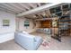 Finished basement featuring an open layout with sofas, a spiral staircase, and exposed ceiling beams at 207 S Gum St, Summerville, SC 29483