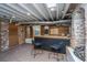 Finished basement featuring exposed ceiling beams, a bar area, and wood paneled walls at 207 S Gum St, Summerville, SC 29483