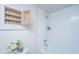 Bright bathroom with a white tub, shower with white subway tile, and a rustic wall cabinet at 207 S Gum St, Summerville, SC 29483