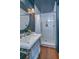 Bathroom with stylish round mirror, vessel sink, and walk-in shower with subway tile at 207 S Gum St, Summerville, SC 29483