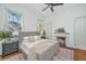 Relaxing bedroom with a ceiling fan, and lots of natural light streaming through the windows at 207 S Gum St, Summerville, SC 29483