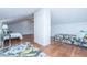 Attic bedroom with hardwood floors, white walls, a sloped ceiling, and two comfortable beds at 207 S Gum St, Summerville, SC 29483