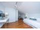 Attic bedroom features hardwood floors, white walls, a sloped ceiling, and a work desk at 207 S Gum St, Summerville, SC 29483
