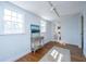 Bedroom with hardwood floors, console table, and adjacent bathroom at 207 S Gum St, Summerville, SC 29483