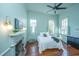 Light-filled bedroom with wood floors, fireplace, ceiling fan, and neutral decor at 207 S Gum St, Summerville, SC 29483