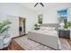Bright bedroom with a ceiling fan, and a ensuite bath through the double doors at 207 S Gum St, Summerville, SC 29483