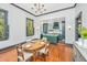 Open dining area featuring hardwood floors, a wood table and chairs, and a view to the updated kitchen at 207 S Gum St, Summerville, SC 29483