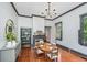 Charming dining area with a fireplace, hardwood floors, and natural light streaming through the windows at 207 S Gum St, Summerville, SC 29483
