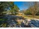 Beautiful home featuring a inviting porch, set amongst lush mature trees and landscaping at 207 S Gum St, Summerville, SC 29483