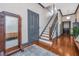 Elegant foyer showcasing hardwood floors, staircase, mirror and wooden bench at 207 S Gum St, Summerville, SC 29483